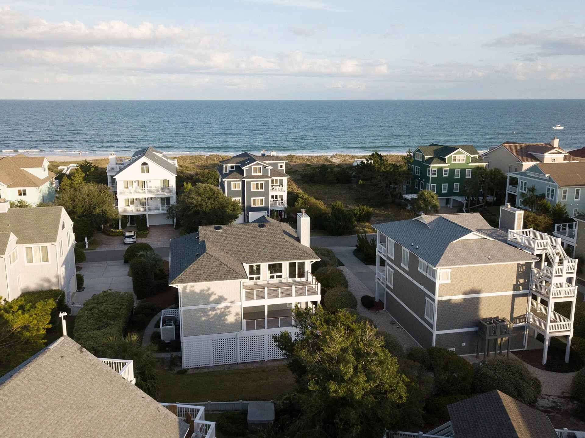Aerial view of custom beach homes near the shoreline by Balding Design Build in Wrightsville Beach, NC