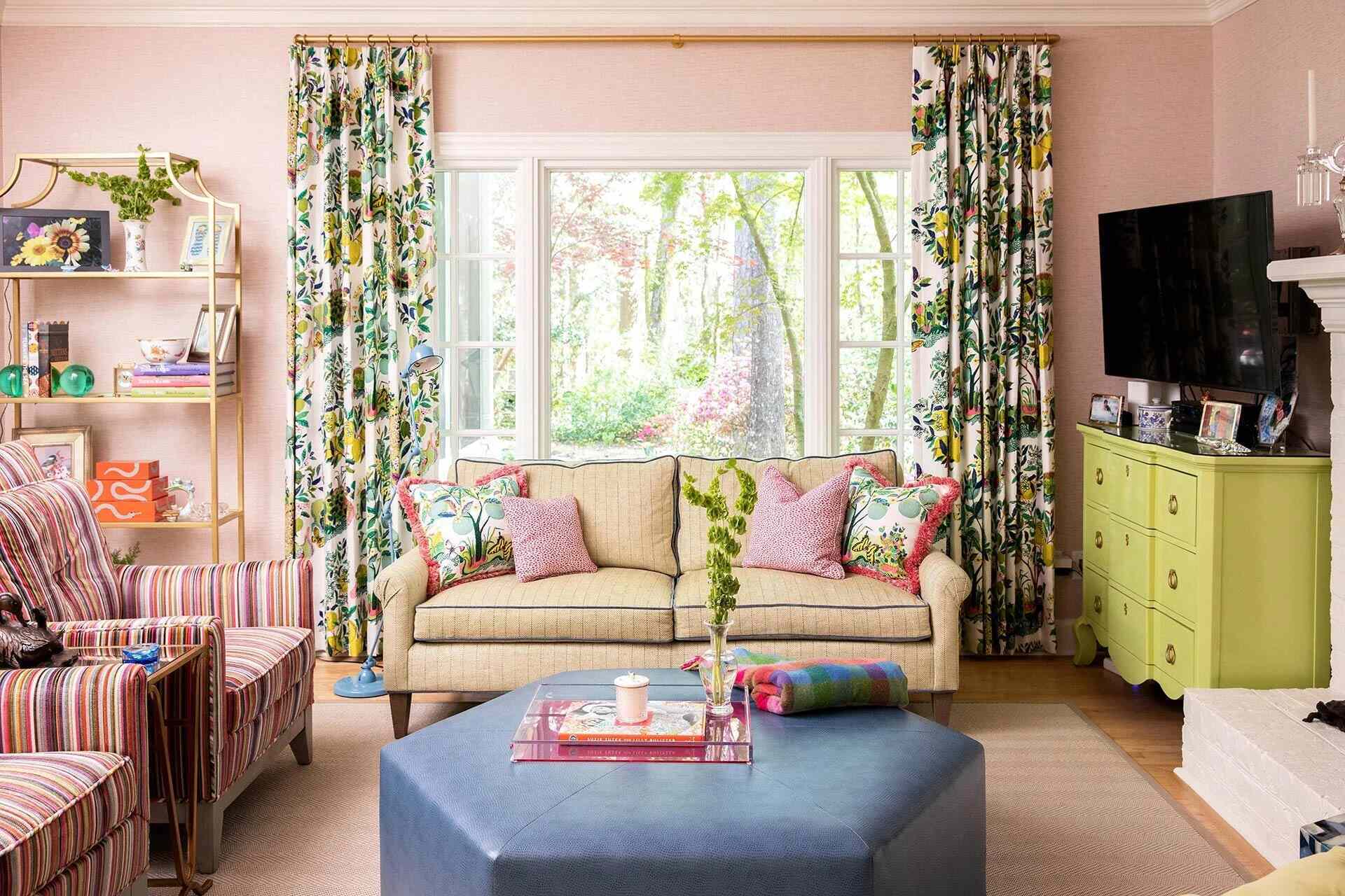 Colorful living room with floral drapes and large picture window in a custom Wilmington, NC home by Balding Design Build