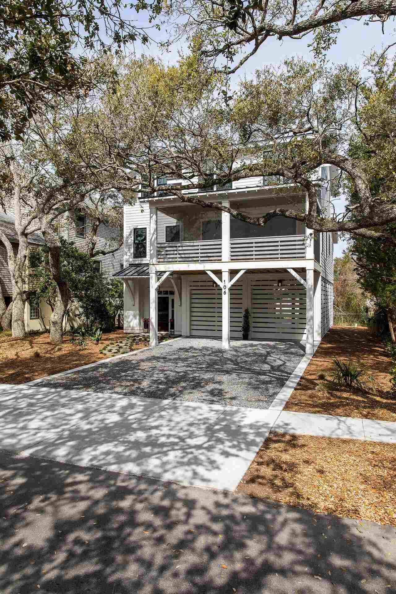 Contemporary coastal home with upper balcony and gravel driveway in Wilmington, NC by Balding Design Build