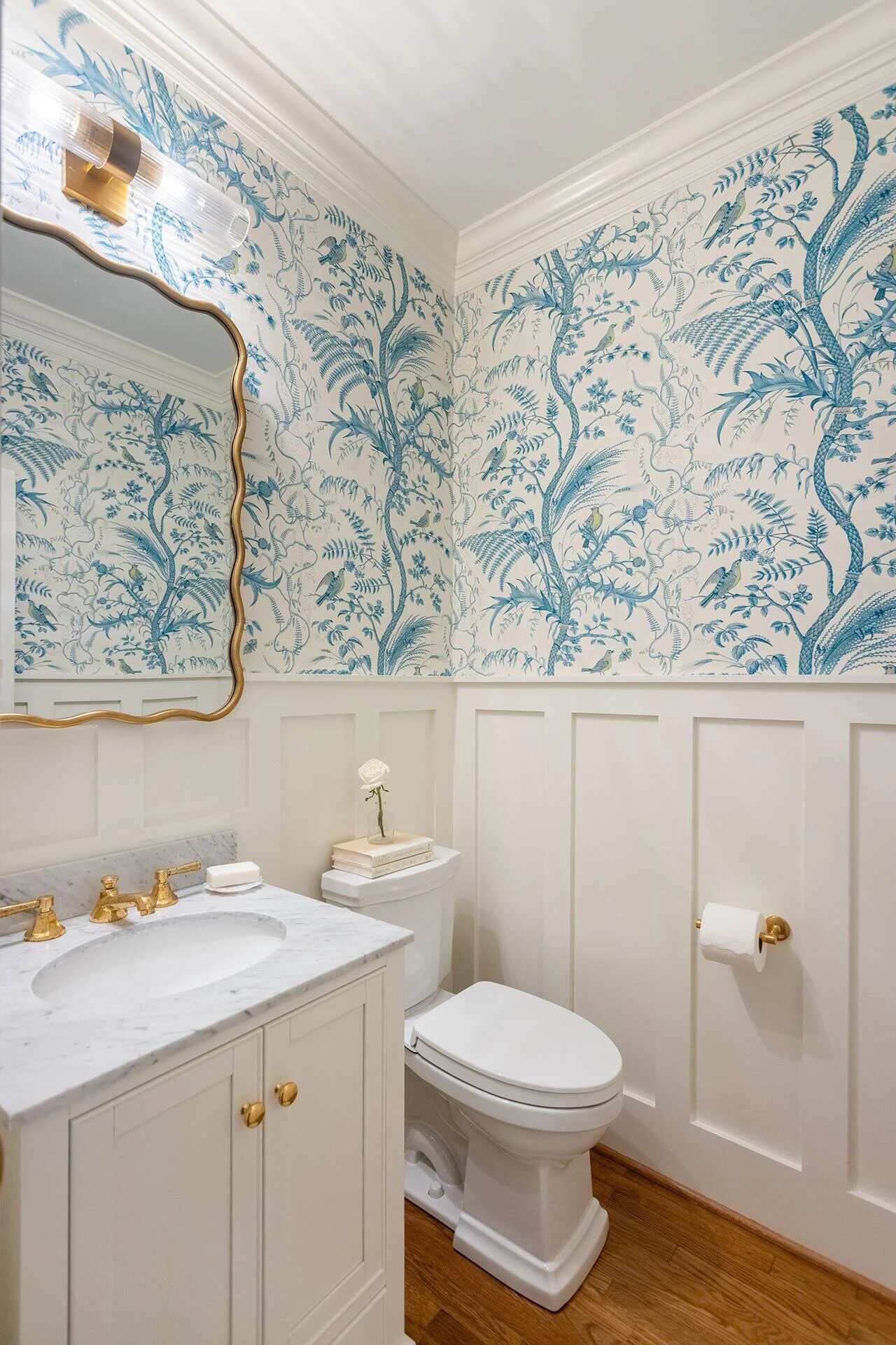 Elegant powder room with blue and white botanical wallpaper in a custom Balding Design Build home in Porters Neck Plantation, NC