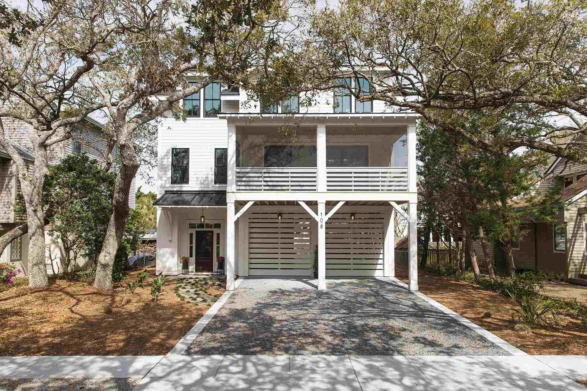Elevated coastal custom home with modern siding and large balcony in Wilmington, NC by Balding Design Build