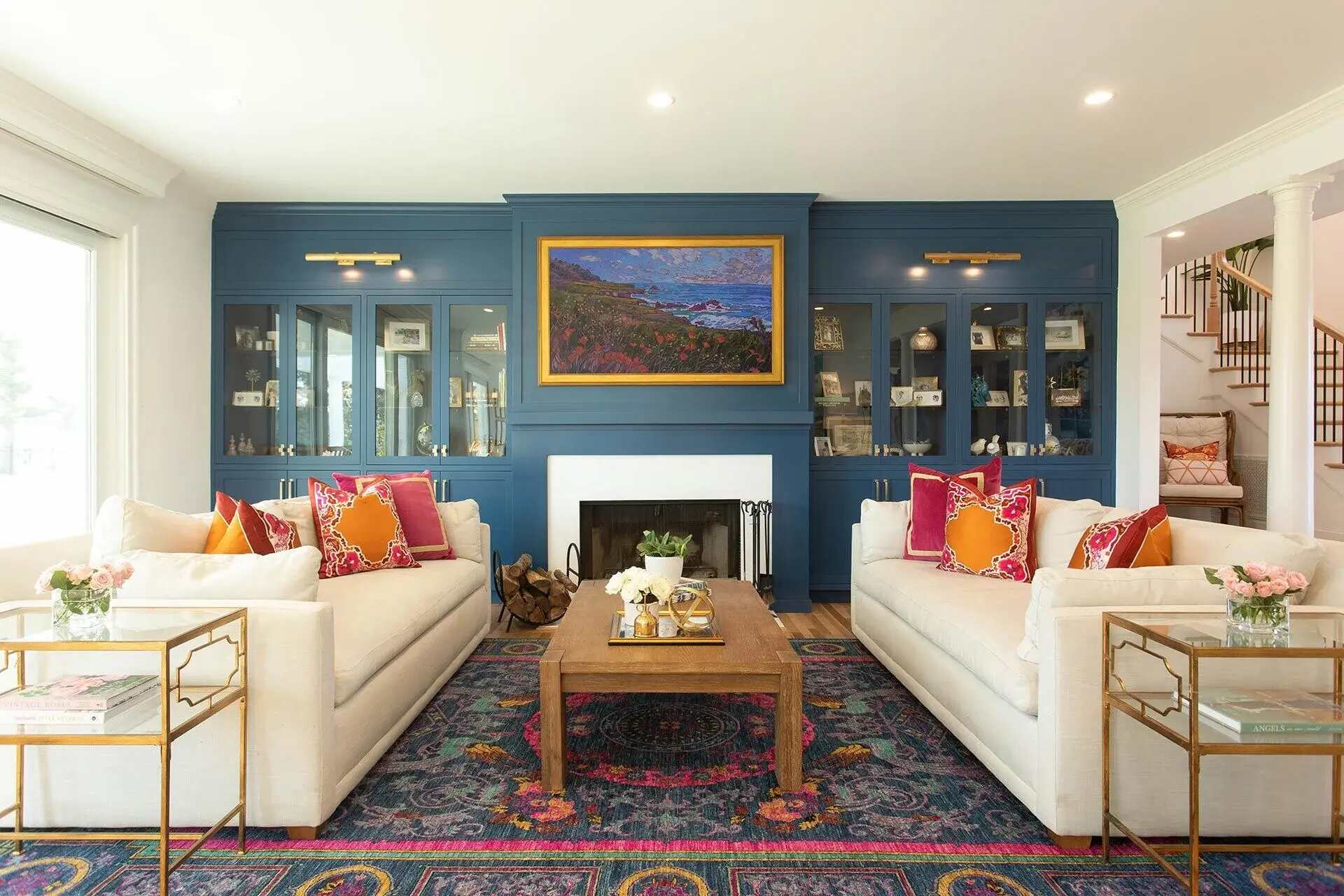 Living room with navy blue built-ins and colorful accents in a Wilmington, NC custom home by Balding Design Build