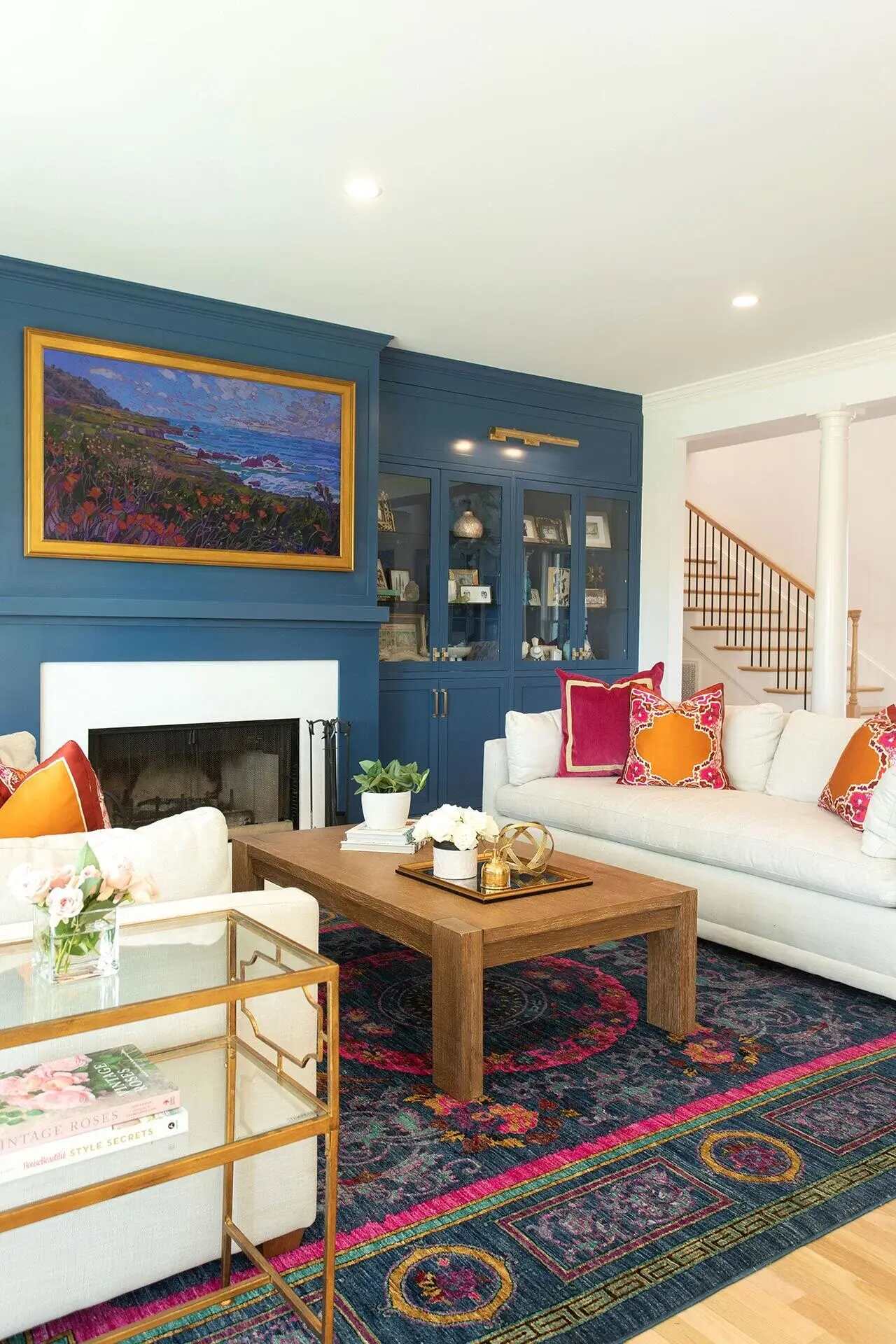 Side view of custom living room built-ins with framed artwork and coastal decor by Balding Design Build in Wilmington, NC