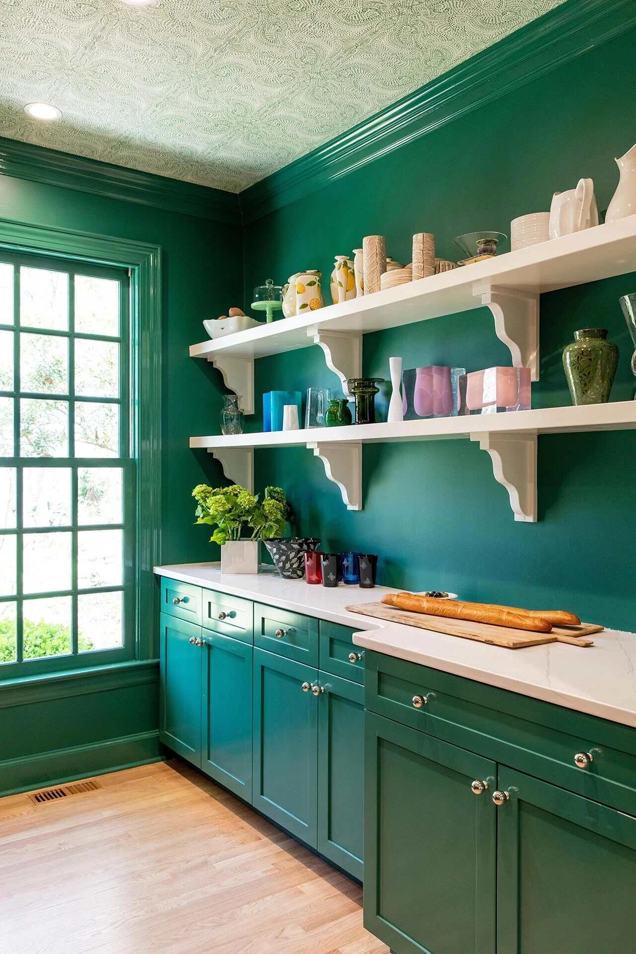 Stylish green pantry with white quartz countertops and display shelves in a Wrightsville Beach, NC home by Balding Design Build