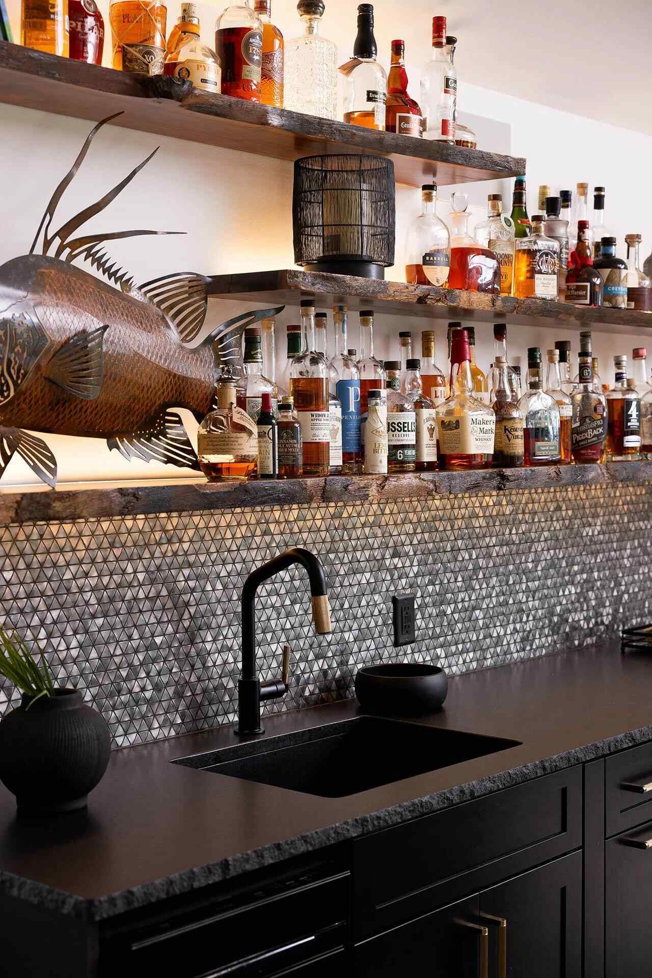 Stylish wet bar design with black cabinetry and metallic backsplash by Balding Design Build in Wilmington, NC