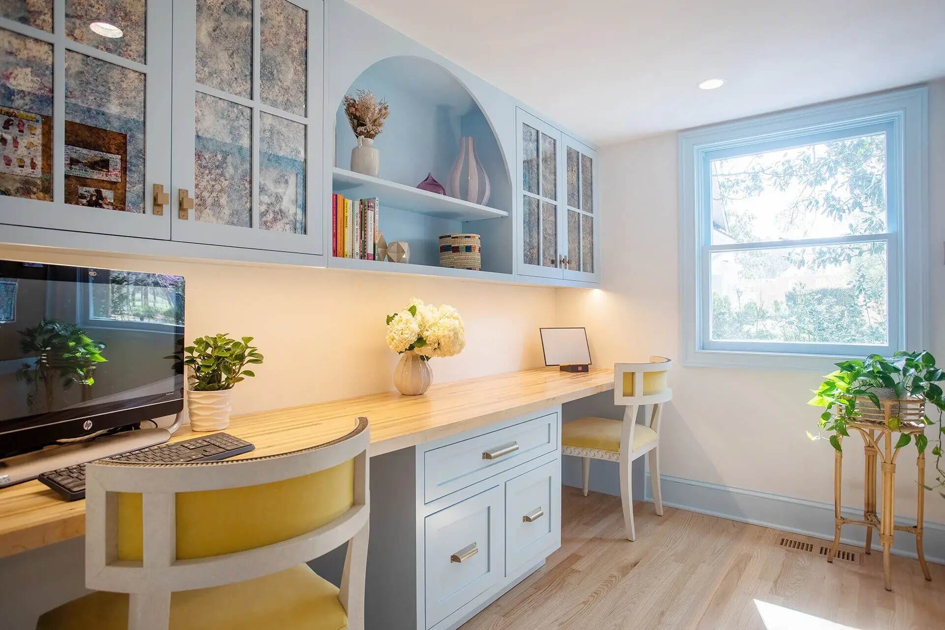 Wilmington, NC custom home workspace featuring built-in shelving, natural wood countertops, and bright lighting by Balding Design Build