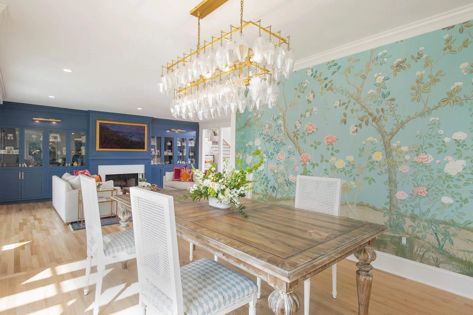 Elegant dining room with floral wallpaper and statement chandelier in a Wilmington, NC custom home by Balding Design Build